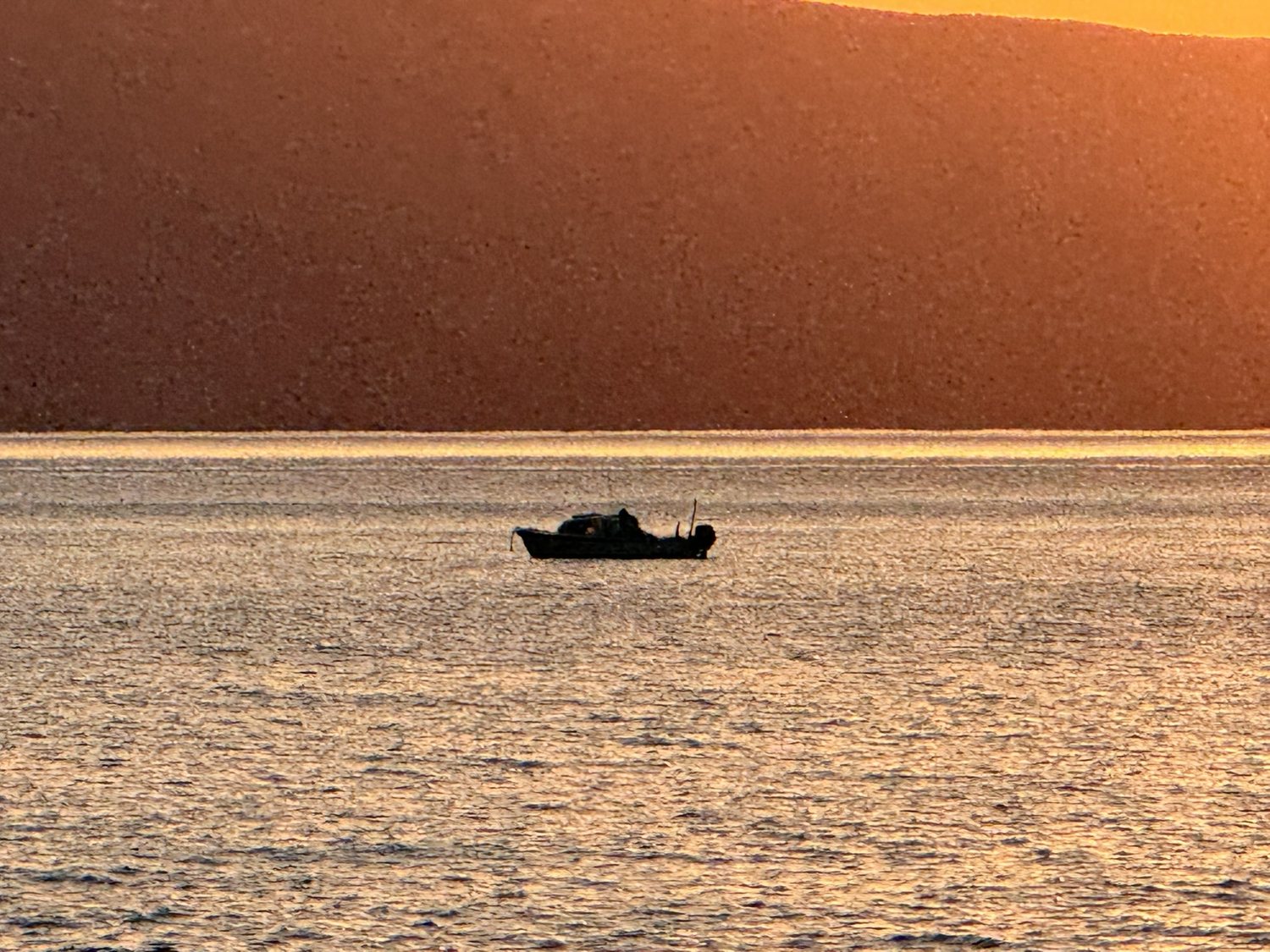 Boat on golden Adriatic sea